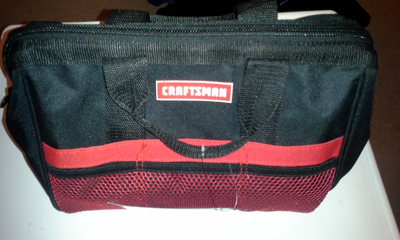 A bag from Crafstman. Sturdy sides, hard cardboard bottom inside. Currently holds my crescent wrenches.